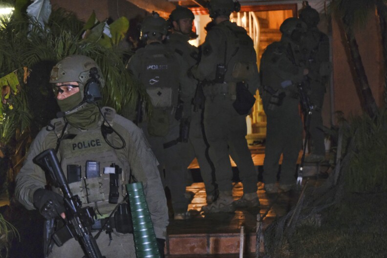 DEA agents search a residential house during an arrest of a suspected drug trafficker on Wednesday, March 11, 2020 in Diamond Bar, Calif. 