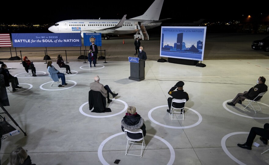 With a socially distanced audience of supporters and journalists, Democratic presidential nominee Joe Biden delivers remarks at Milwaukee Mitchell International Airport in Wisconsin on Friday.