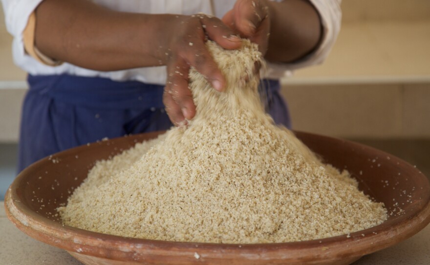 A woman prepares couscous in a small Amazigh (Berber) hamlet on the eastern slopes of Morocco's High Atlas Mountains.