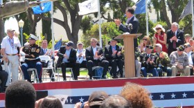 Mitt Romney applauds a local veteran during a Memorial Day ceremony at the Veterans Museum and Memorial Center, May 28, 2012.