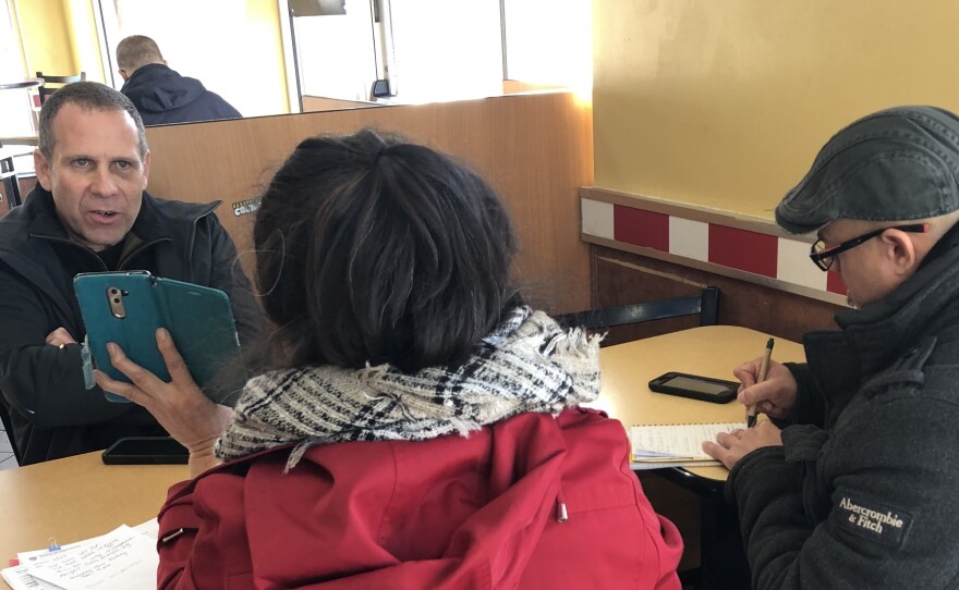 Nick Selby and NYPD officer Luis Sayan interview a retired New York City teacher who lost more than $300,000 to online scammers posing as Chinese police.