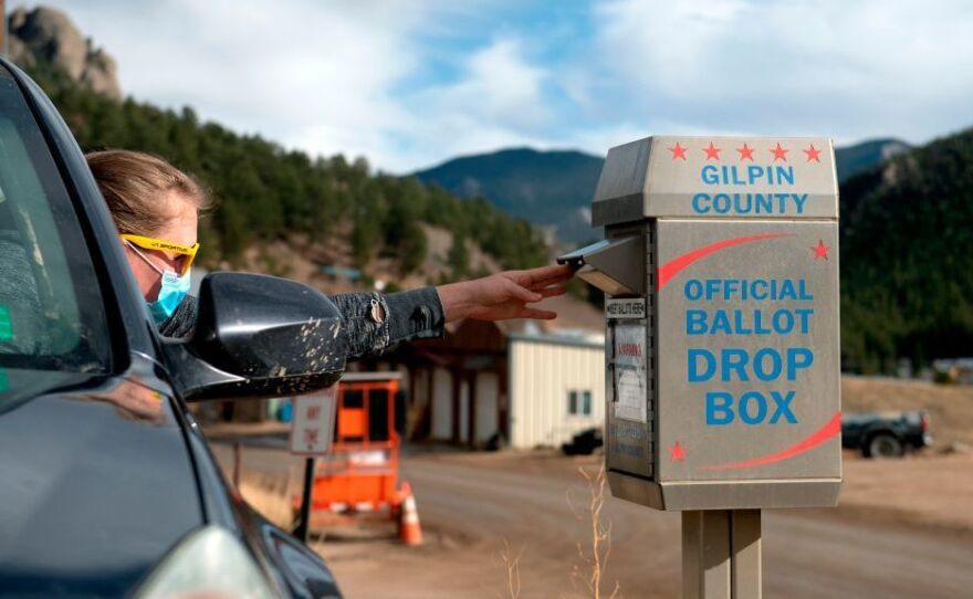 A voter drops off her ballot for the U.S. presidential election on Nov. 3, 2020, in Rollinsville, Colo. Colorado's voting laws got fresh attention this week after the MLB decided to move its All-Star game to the state to protest Georgia's new legislation.