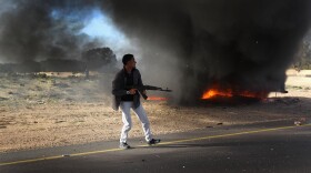 A rebel fighter advances on the front line against Libyan government forces on March 2, 2011 in al-Brega, Libya. 