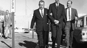 Joseph Corbett (center), who was convicted of killing millionaire Adolph Coors III, is led to the Jefferson County  courthouse in Golden, Colo., in 1961.