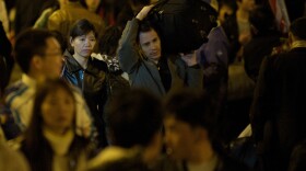 The Zhangs are crowded by passengers at Guangzhou Railway Station, heading home for Chinese New Year.