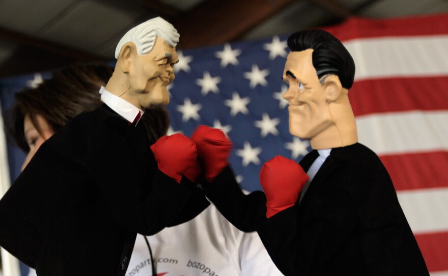 Ahead of a January 2012 GOP debate, boxing puppets of New Gingrich, left, and Mitt Romney, right, are displayed.