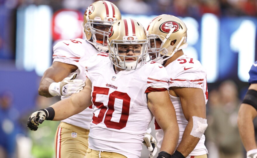 San Francisco 49ers linebacker Chris Borland (50) is seen here in a 2014 game against the New York Giants. Borland, who had two interceptions in that game, has announced that he is retiring from the NFL after his rookie season.