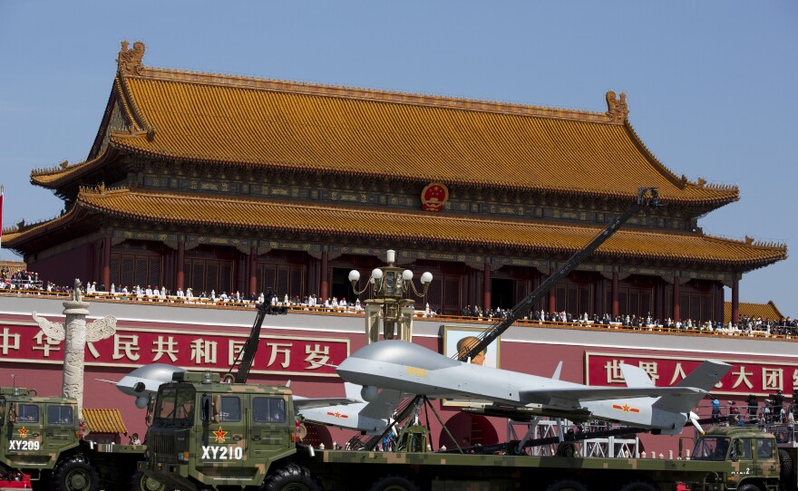 Military vehicles carrying Wing Loong, a Chinese made medium-altitude long-endurance unmanned aerial vehicle, drive past Tiananmen Gate during a military parade to commemorate the 70th anniversary of Japan's World War II defeat in Beijing on Thursday.