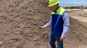 Republic Service's Chris Seney handles the commercial grade mulch created at a South County landfill on Jul 5, 2022.