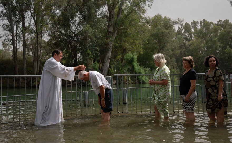 Christians from San Paolo, Brazil get blessed in the Jordan river in Israel on May 11, 2024.
