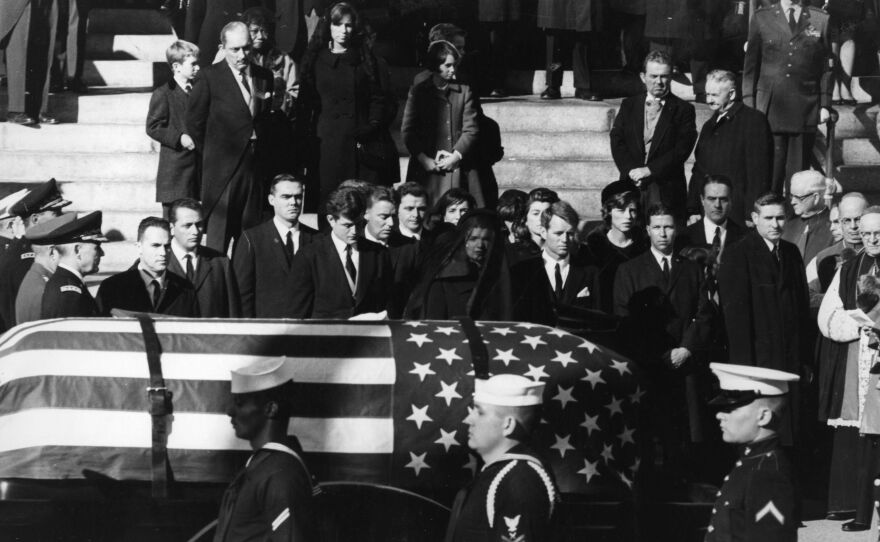 Jacqueline Kennedy (center), with Edward and Robert Kennedy on either side, watches the coffin of President John F. Kennedy pass on Nov. 25, 1963.