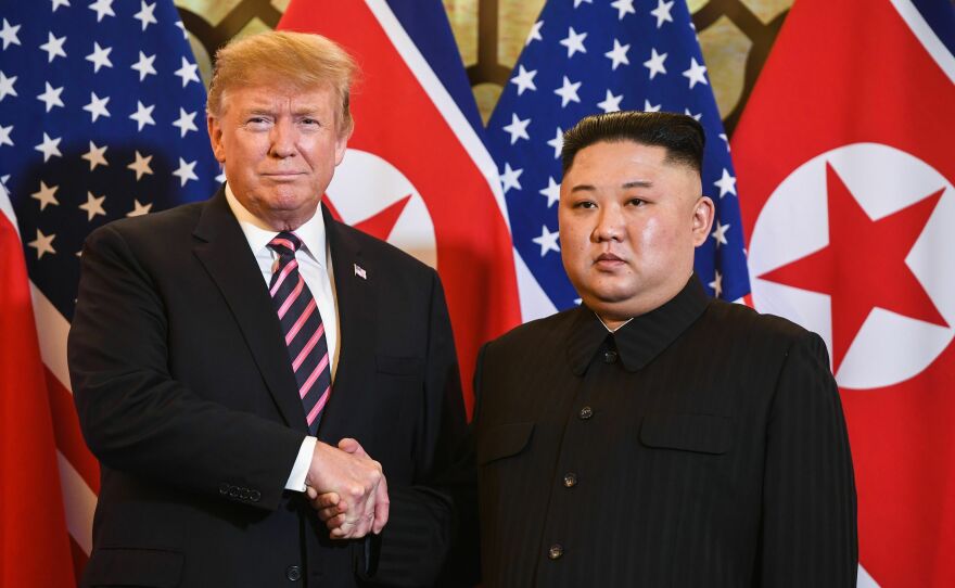 Donald Trump shakes hands with Kim Jong Un before a meeting in Hanoi in February 2019.