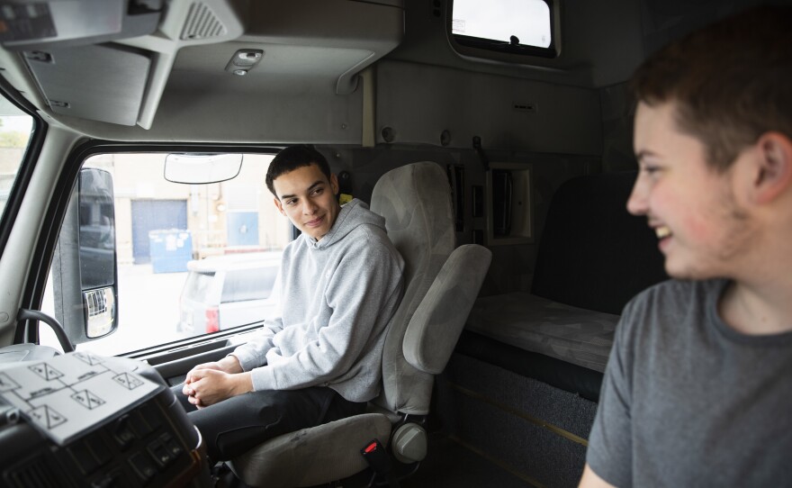 Seniors Peter Vilas Novas and Joshua Hewitt chat in the cab of the truck they're learning on. Both think they'd like to get into long-haul trucking once they earn their commercial driver licenses.