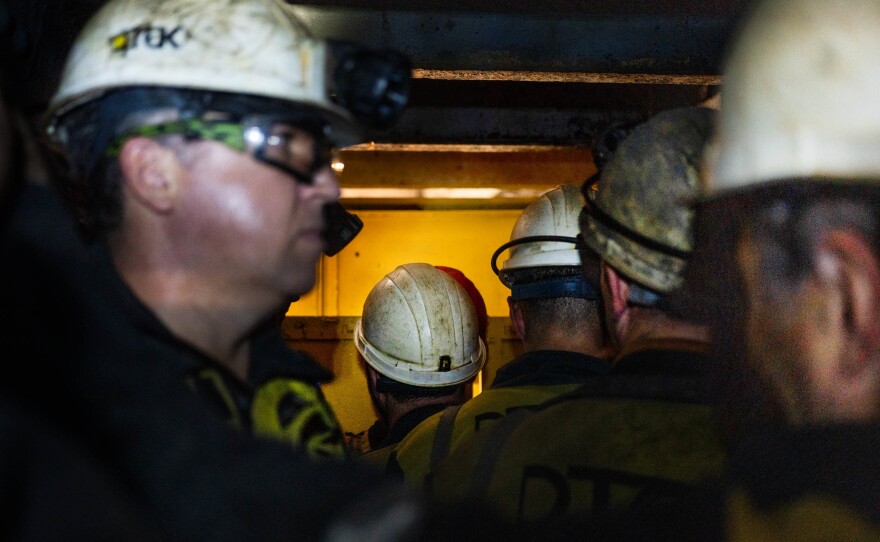 Workers wait to get off an elevator at a coal mine in eastern Ukraine.