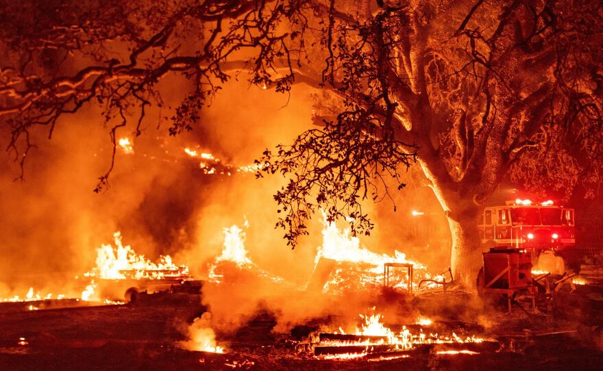 Firefighters work the scene as the Glass fire continues to burn in Calistoga, Calif., on Oct. 1, 2020. The United States's west coast experienced a record-breaking fire season in 2020, with five of the state's six biggest blazes in history burning simultaneously, and nearly four million acres scorched.