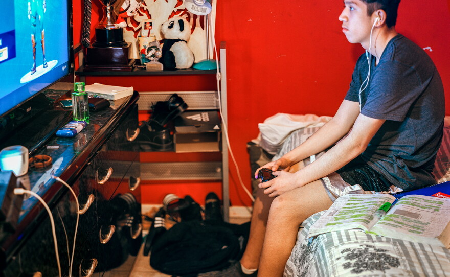 Oliver Villanueva takes a break from studying and plays Fortnite in 2018.