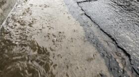 Rain water runs down a street during a storm in San Diego, Dec. 4, 2019. 