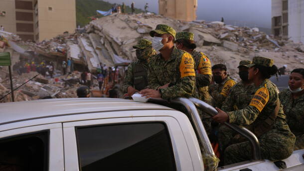 Venezuelan firefighters and volunteers search for possible victims atop a collapsed building in Caraballeda, La Guaira state, Venezuela, on Saturday, June 27, 2026.