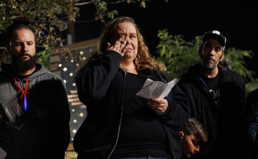 At the Healing Garden in Las Vegas on Nov. 9, 2018, Las Vegas shooting survivor Stacie Armentrout reads the names of victims from the Thousand Oaks, Calif., shooting. One of the people killed in Thousand Oaks was a Route 91 survivor, a friend Armentrout met through the Route 91 community.