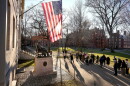 FILE - People take photos near a John Harvard statue, left, on the Harvard University campus, Jan. 2, 2024, in Cambridge, Mass.