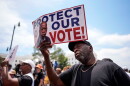 A demonstrator holds a sign saying "PROTECT OUR VOTE!" at a May 16 rally in Montgomery, Ala., responding to the recent U.S. Supreme Court ruling that weakens Voting Rights Act protections against racial discrimination in redistricting.