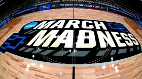 FILE - March Madness logo sis displayed at center court during the opening rounds of the NCAA college basketball tournament in Pittsburgh, Wednesday, March 20, 2024.