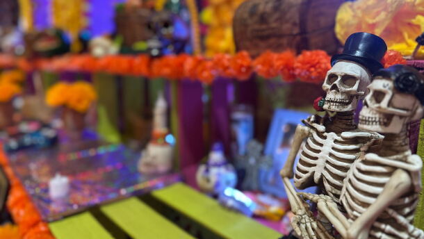 Two embracing skeletons sit on an altar at the Sherman Heights Community Center on Oct. 15, 2025