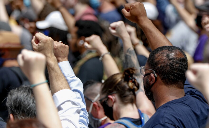 Demonstrators raise their fists during a May 30 march in Pittsburgh to protest the death of George Floyd.