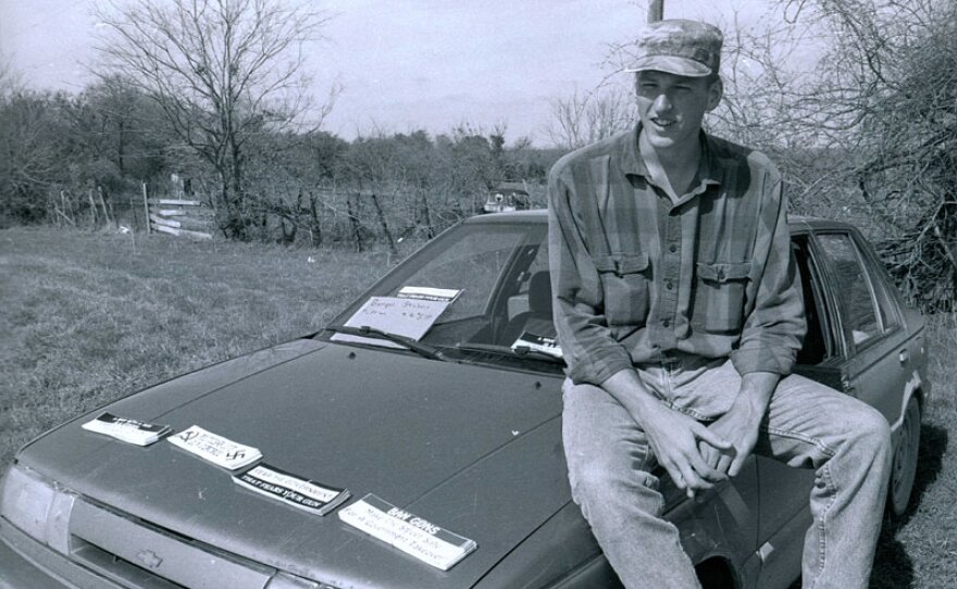 Timothy McVeigh selling bumper stickers outside the Branch Davidian compound during the 1993 federal siege. Waco, Texas.