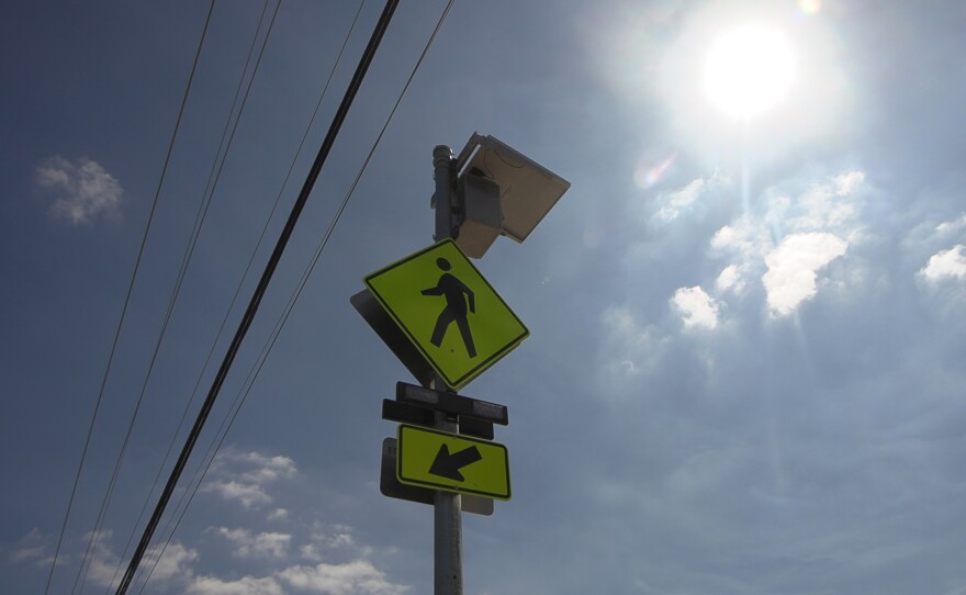 The sun glares over a crosswalk sign in front of Village View County Park in Fallbrook, Sept. 30, 2025.
