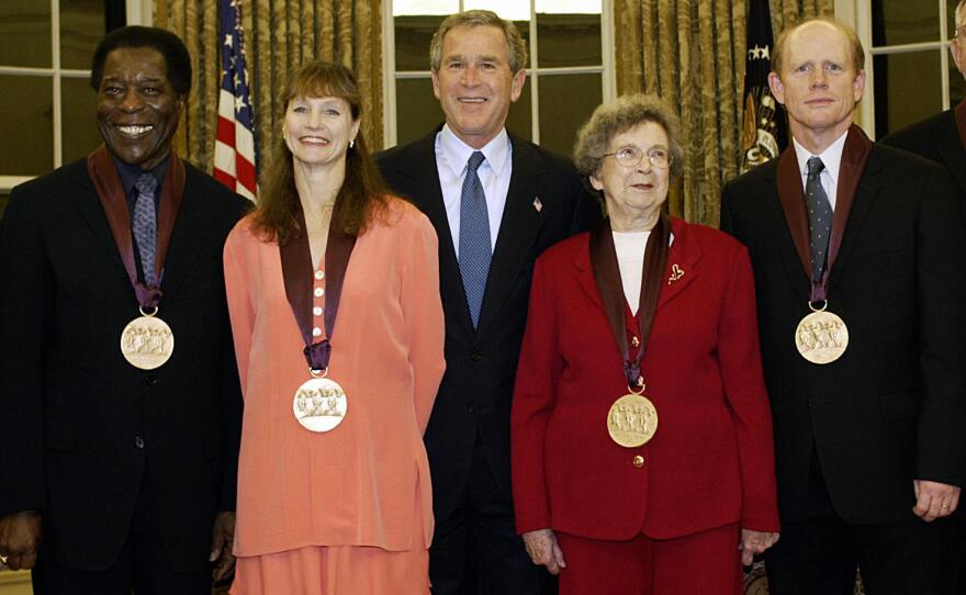 Beverly Cleary, in red, with President George W. Bush and other recipients of the National Medal of Arts in the Oval Office of the White House, November 2003.