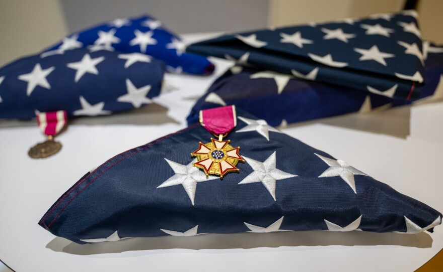 Folded U.S. flags rest on a table at a retirement ceremony for transgender service members in Washington, D.C.