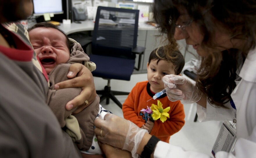 Nurse Julietta Losoyo gives Derek Lucero a whooping cough vaccination at the San Diego Public Health Center on Dec. 10, 2014.