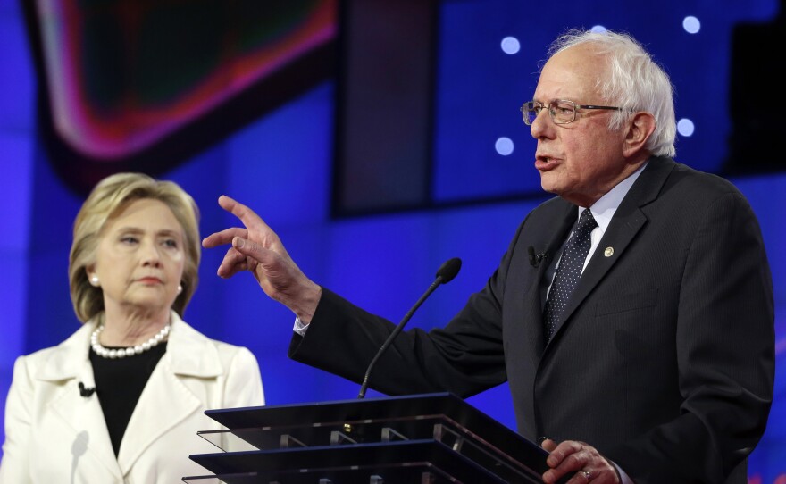 Sen. Bernie Sanders, I-V.t, right, speaks as Hillary Clinton looks on during an April Democratic debate in New York.