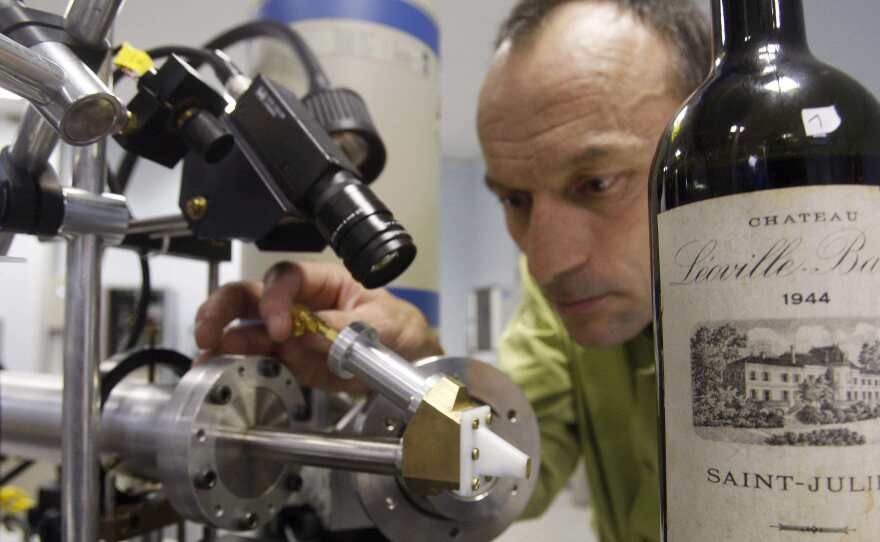 Herve Guegan of the Nuclear Research Centre of Bordeaux runs a test on a 1944 vintage bottle of Medoc wine.