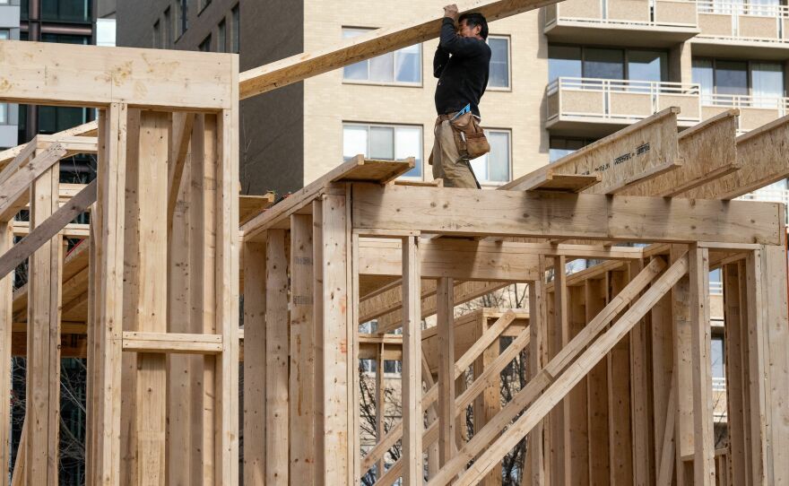 Construction workers build a residential house in Bethesda, Md., on Jan. 18, 2023. The housing sector has been hurt by the Fed's aggressive rate hikes, raising some concerns about the broader economy.