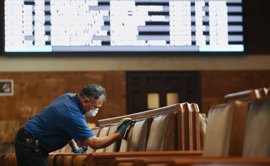 A member of the custodial staff at Los Angeles' Union Station, taking extra care in the waiting area — all part of enhanced cleaning efforts at major transit hubs in response to COVID-19.