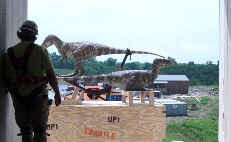A worker loads T-Rex onto the Ark.