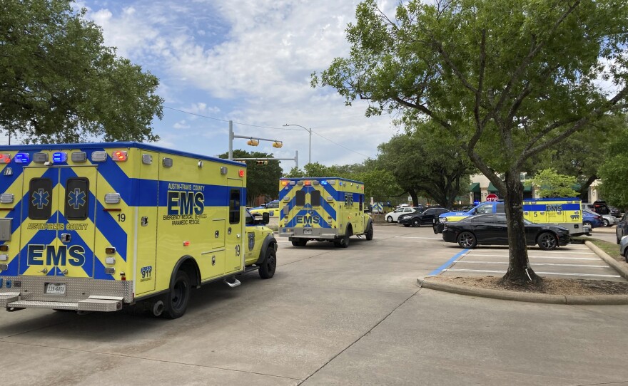 Emergency personnel work at the scene of a shooting Sunday in Austin. Police said three people were killed.