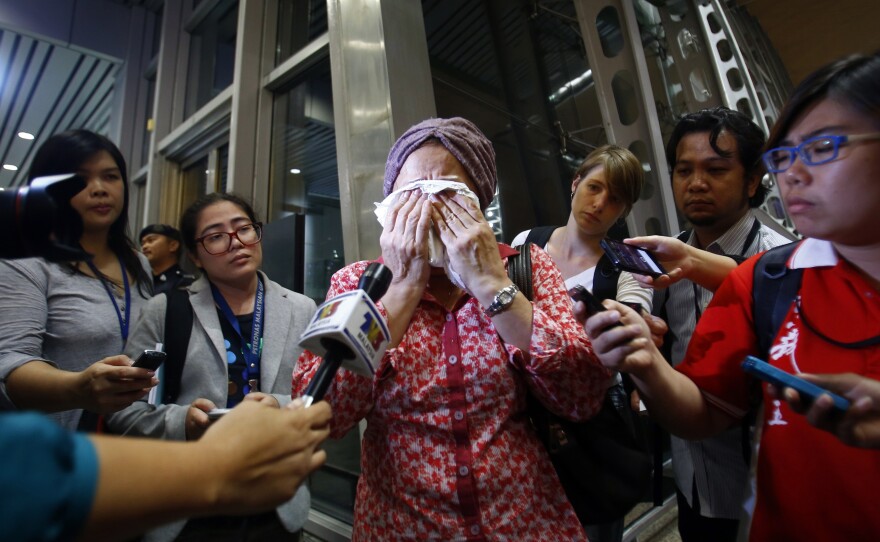 A woman at Kuala Lumpur International Airport reacts to news of the crash.