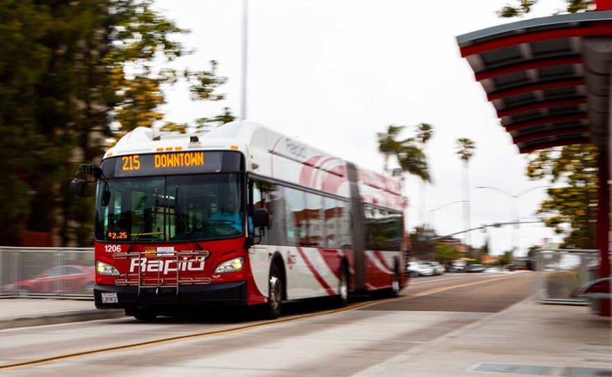 The Mid-City Rapid 215 bus approaches a stop on University Avenue in San Diego while traveling down a dedicated lane on Park Boulevard on April 16, 2019.