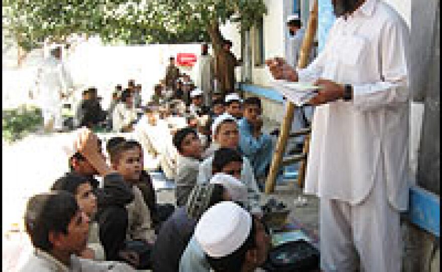 Students listen to their teacher during an Arabic history class.