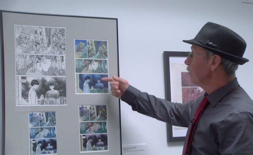 Colorist Steve Oliff points to examples of how he colored the Japanese manga "Akira" at the new Comic-Con Museum exhibit "From Big Dots to the Digital Universe." Oct. 3, 2023.