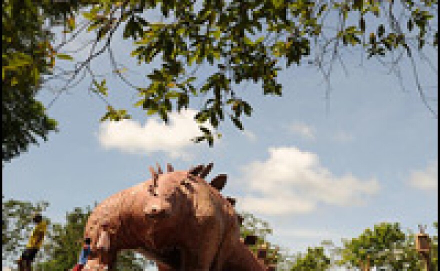 Two children play in the "Jurassic Park" at Hacienda Napoles. Escobar built life-size models of a <em>Tyrannosaurs rex,</em> a triceratops and a brontosaurus.