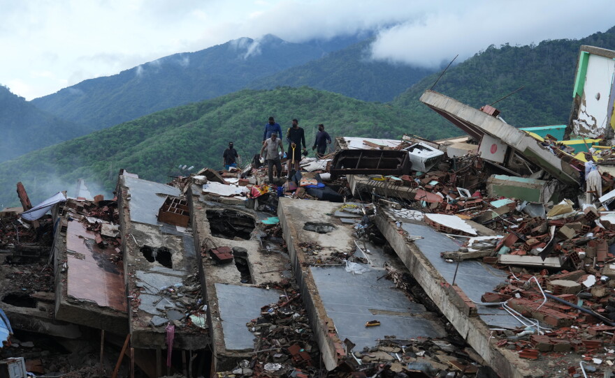 Residents on Tuesday search through the rubble of a building that collapsed in the June 24 earthquakes in La Guaira, Venezuela.