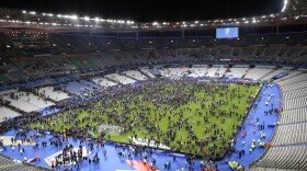 Spectators invade the pitch of the Stade de France stadium after the international friendly soccer France against Germany, Nov. 13, 2015 in Saint Denis, outside Paris. 