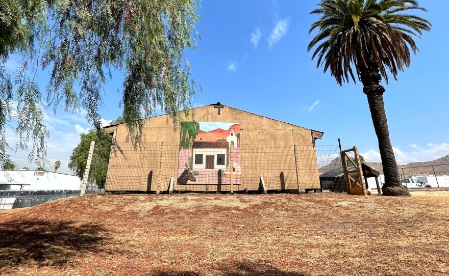 The wooden structure that protects the Trujillo Adobe is decorated with a mural of what the structure once looked like.