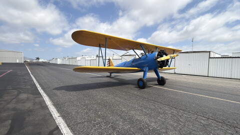 A Boeing-Stearman Model 75; blue plane with yellow wings