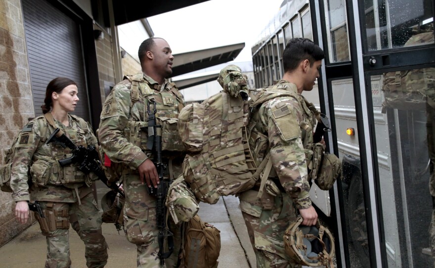 U.S. Army soldiers board a bus in January 2020 at Fort Bragg, N.C., one of the military bases that will likely see population boosts in their 2020 census counts due to a change to how troops deployed abroad were counted.