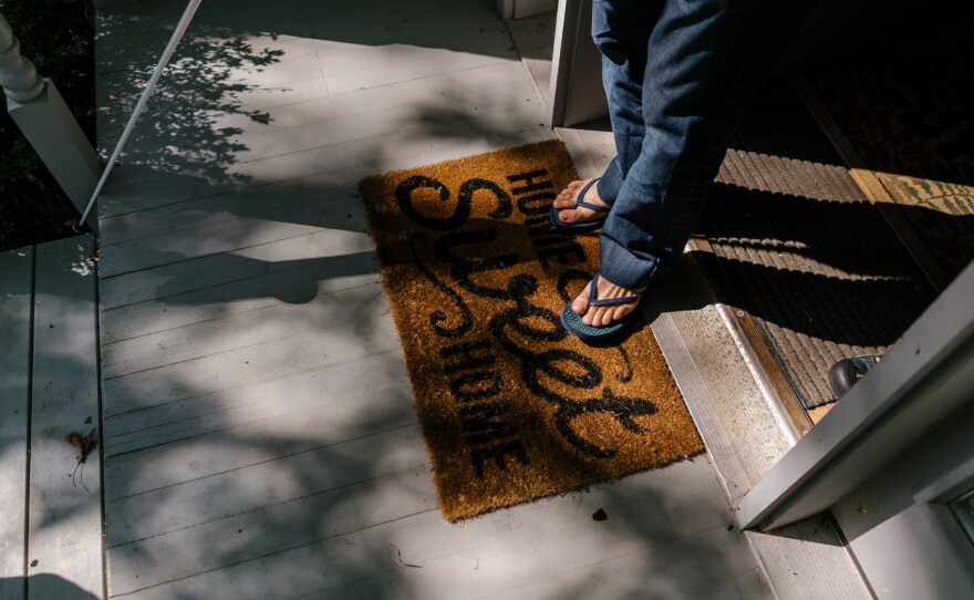 Osama steps out of his home on his way with his wife to pick up his children from the bus.